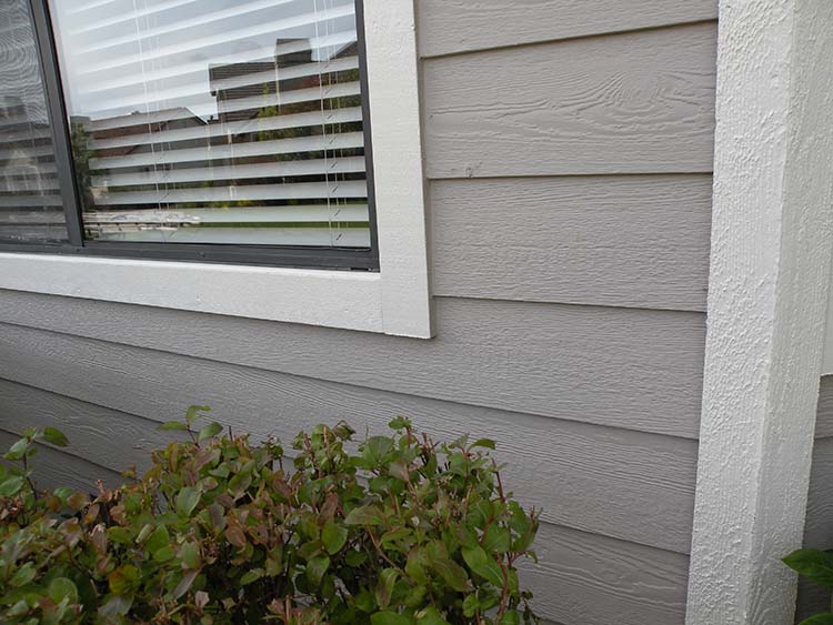 The same window corner rebuilt, primed, and repainted
