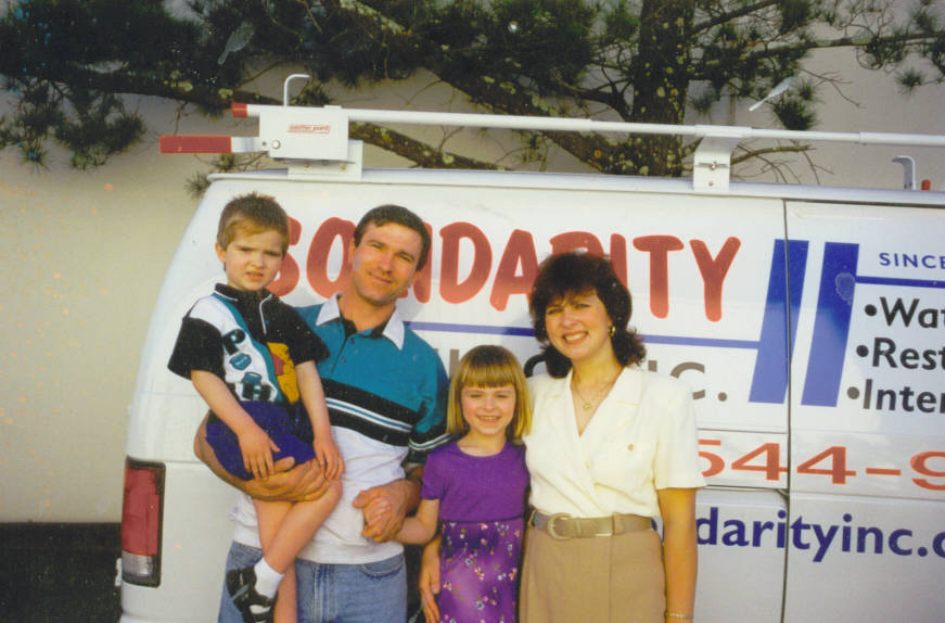 The Kuzmicki family in the early 1990s in front of the original Solidarity Painting van